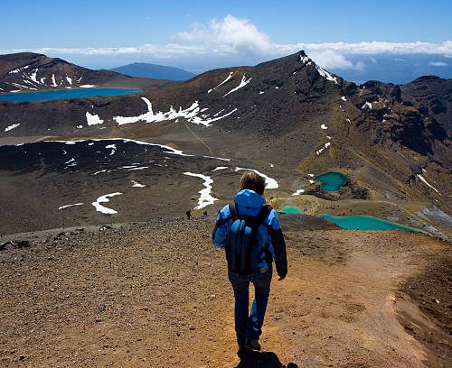 Young Woman walks the Tongariro Crossing on a perfect day.
