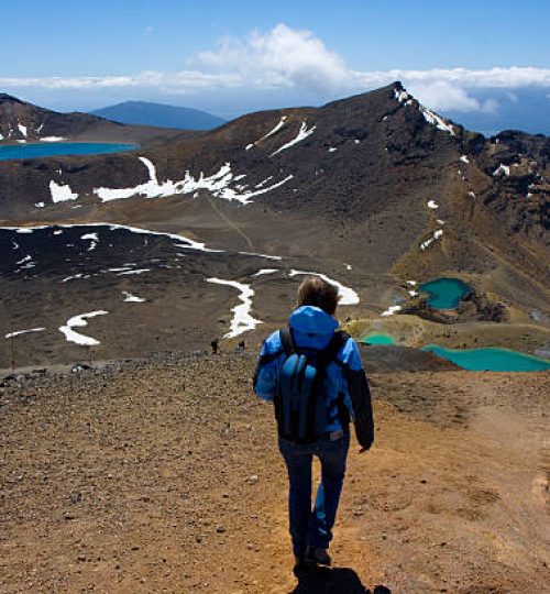 Young Woman walks the Tongariro Crossing on a perfect day.